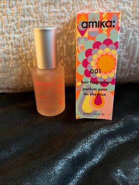 amika hair fragrance in coral and silver packaging